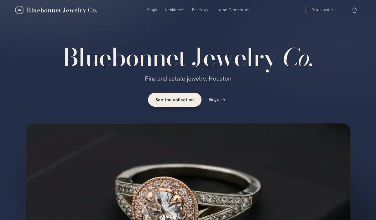 The jewelry store’s home page on a computer: its menu of rings, necklaces, earrings and loose gemstones, the store’s name over deep blue, a See the collection button and a diamond ring.